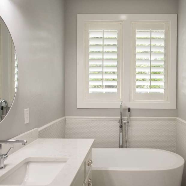 White plantation shutters in bathroom