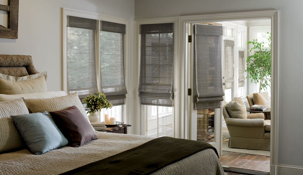 Woven shades in a bedroom