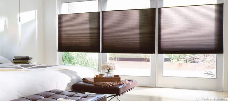 Contemporary San Antonio bedroom with high ceiling windows and vertical cellular shades.