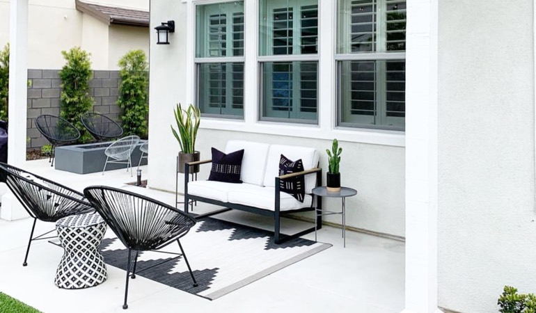 Spending a little time mulching and weeding can help give you a backyard oasis. An outside patio with plantation shutters