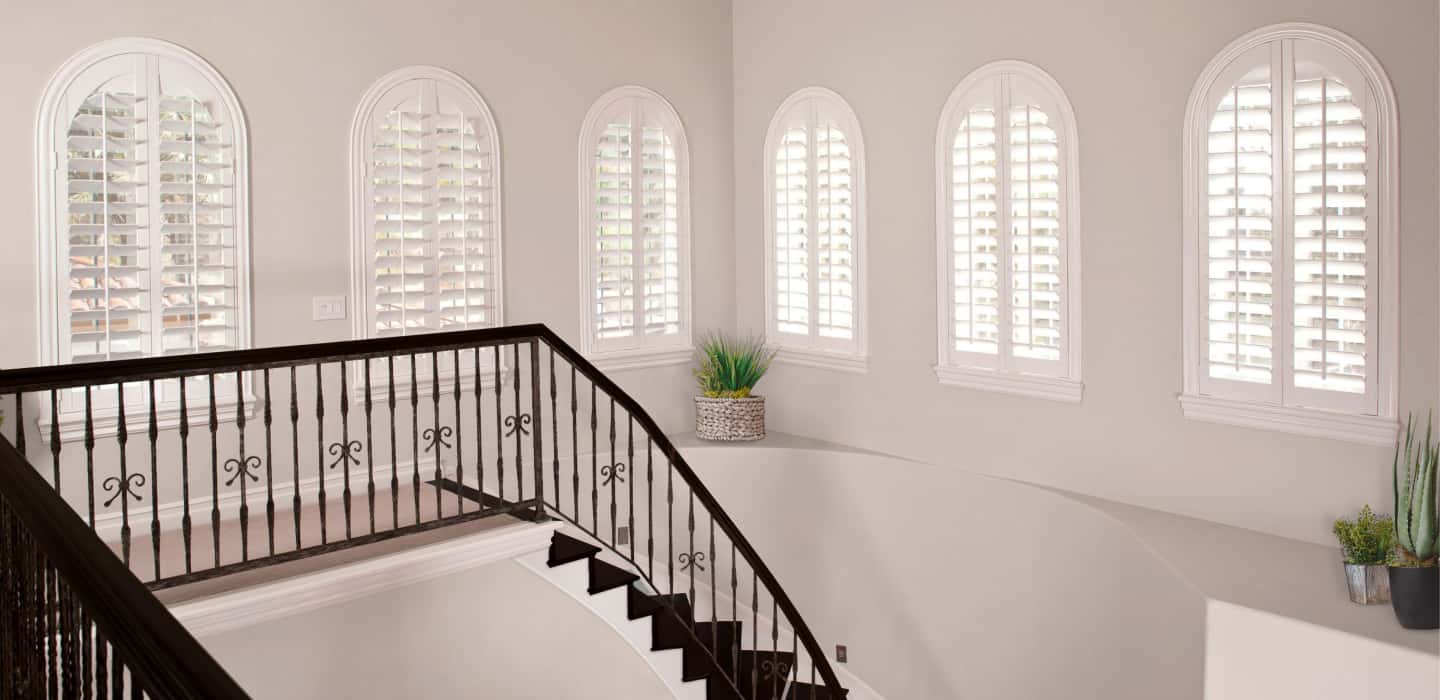 Custom-fitted window coverings cover your entire window without sticking out and catching on the trim. Arched Plantation Shutters