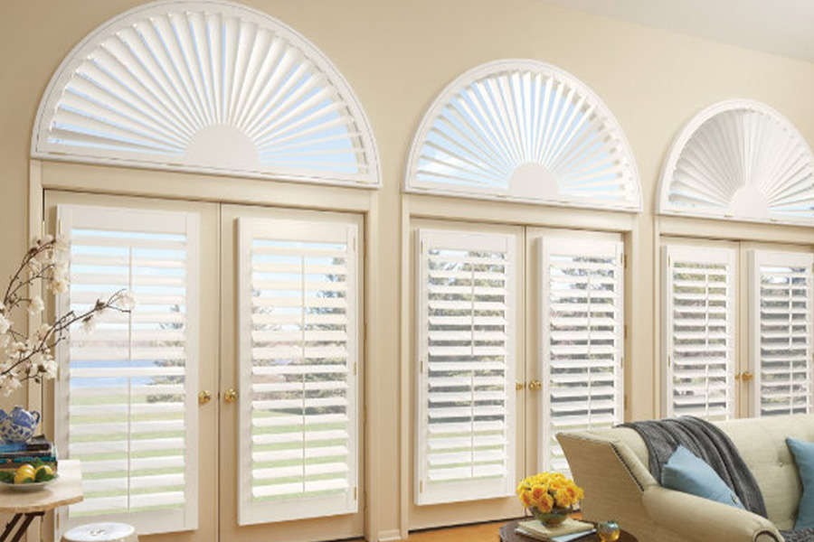 White Polywood shutters on glass doors and custom-made windows.