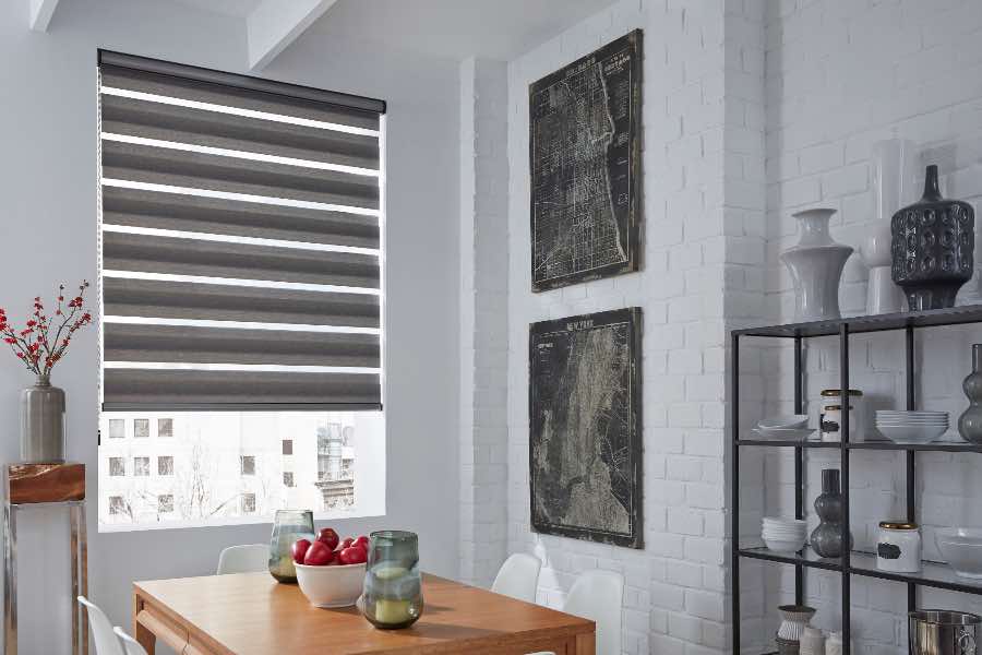Transitional shades let you choose varying levels of natural light for your room. A gray transitional shade on a dining room window