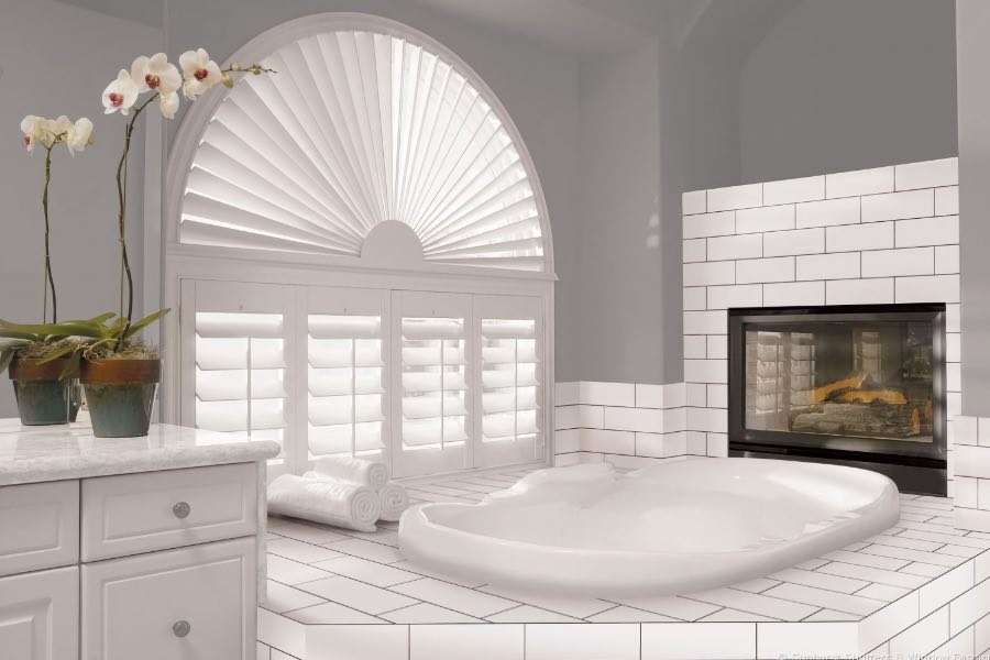 Custom arched plantation shutters in bathroom.