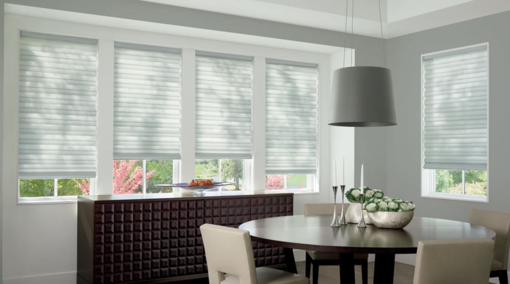 Custom cordless roller shades have a clean look and are appropriate for any room. Cordless motorized shades in a San Antonio dining room