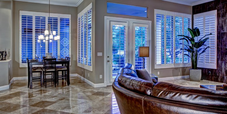 Photo Courtesy of Room Resolutions San Antonio great room with classic shutters and leather furniture.