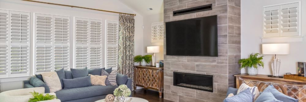 Plantation shutters in a San Antonio living room with fireplace