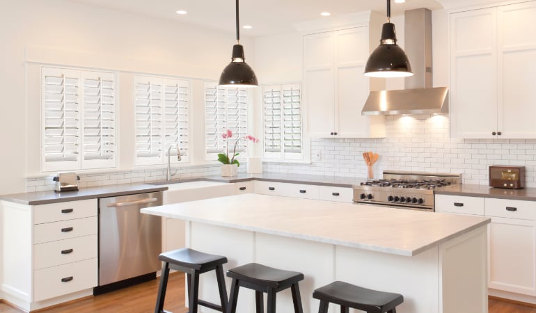 Plantation shutters let you control the amount of light in your kitchen. Plantation shutters in a bright San Antonio kitchen.