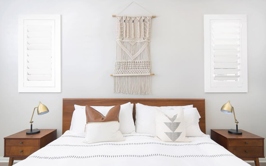 Custom-fitted louvered shutters provide excellent nighttime privacy in San Antonio. Photo Credit: Audrey Crisp Louvered shutters in a bedroom.