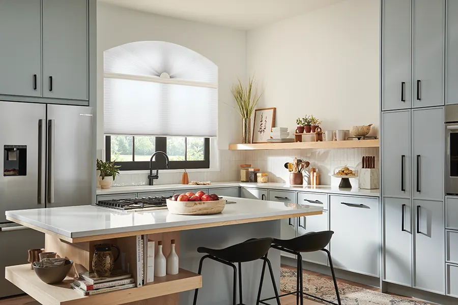 Custom cellular shades are available for arched windows—just have an expert measure and install. arched window above the kitchen sink with cellular shades in white